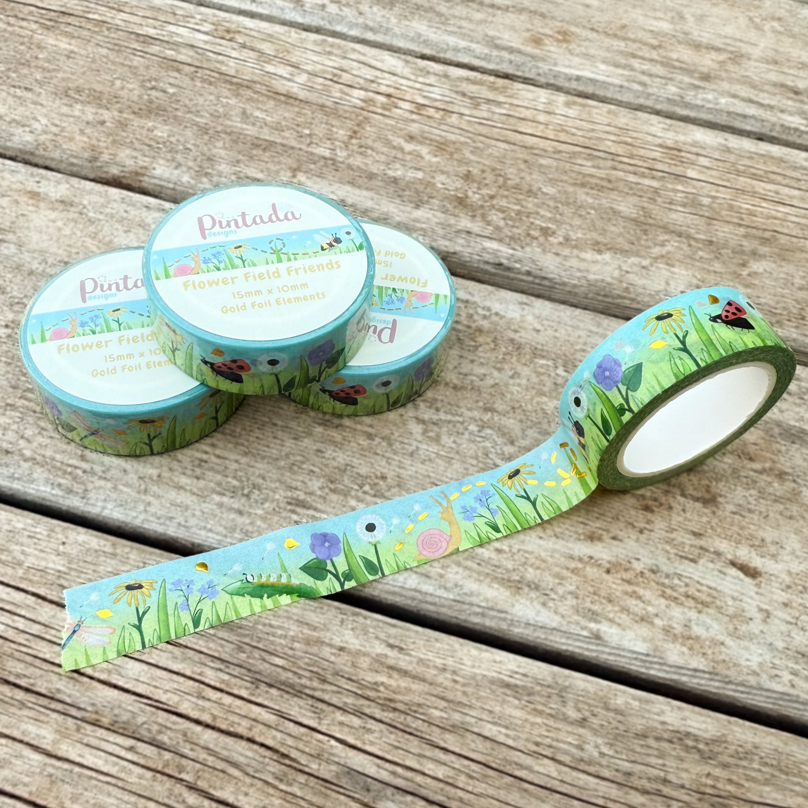 Decorative tape with nature-themed design on a wooden surface